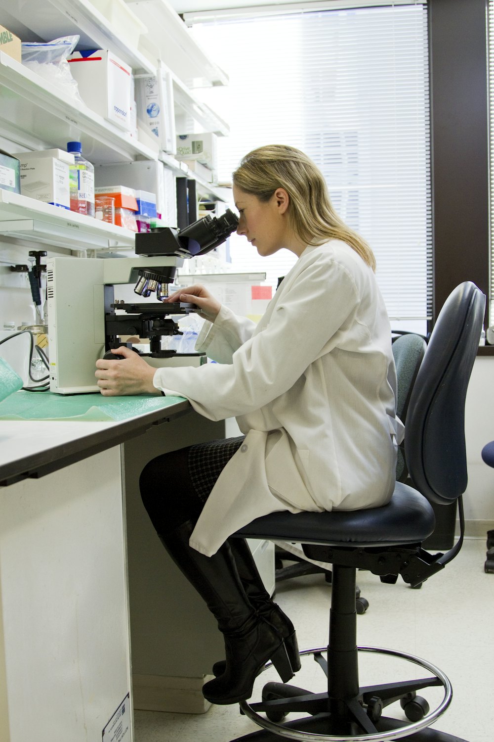 Technologist using a microscope